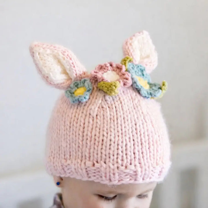 Close-up of the blush Wildflower Bunny Baby Hat with bunny ears and pink and blue flowers