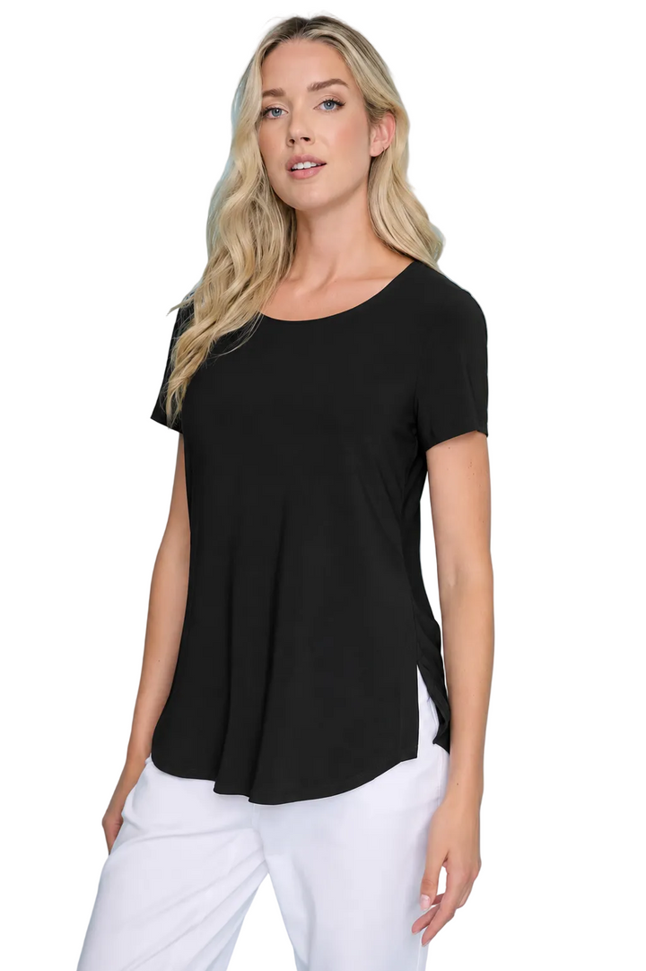 Woman wearing a black t-shirt and white pants against a blue background